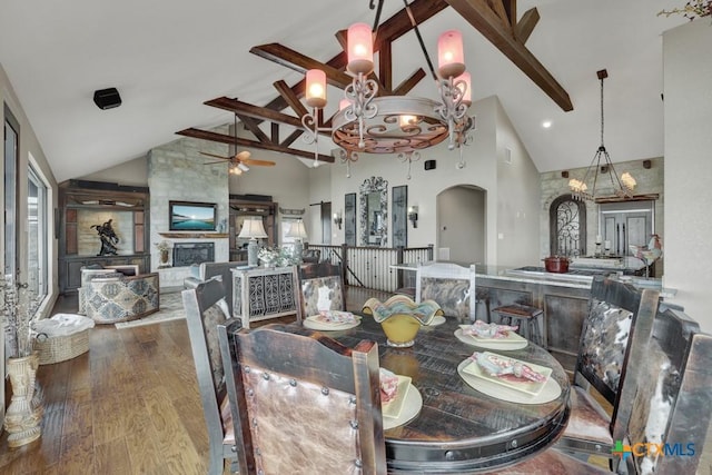 1746 Stagecoach Dr, Canyon Lake, TX 78133 - dining room with high vaulted ceiling, arched walkways, ceiling fan, wood finished floors, and beam ceiling