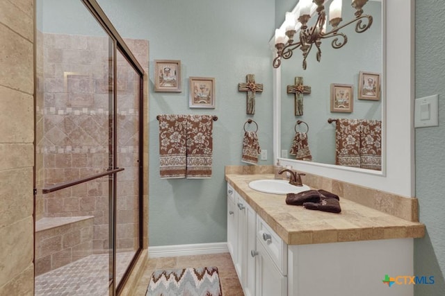 1746 Stagecoach Dr, Canyon Lake, TX 78133 - bathroom featuring a stall shower, vanity, a chandelier, and tile patterned flooring