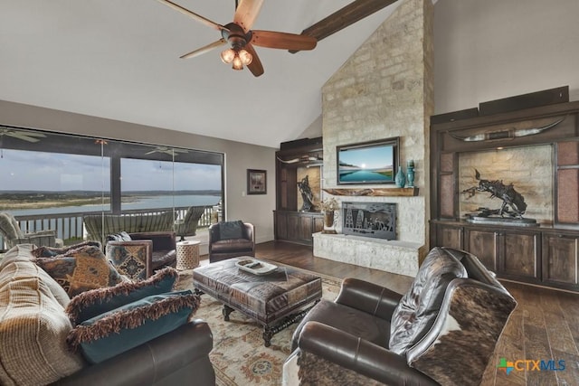 1746 Stagecoach Dr, Canyon Lake, TX 78133 - living room with ceiling fan, high vaulted ceiling, dark wood-style flooring, a stone fireplace, and beam ceiling