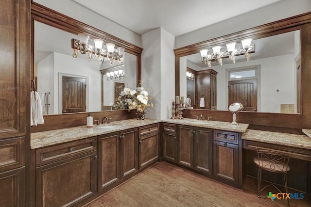 1746 Stagecoach Dr, Canyon Lake, TX 78133 - full bath with a chandelier, double vanity, and wood finished floors