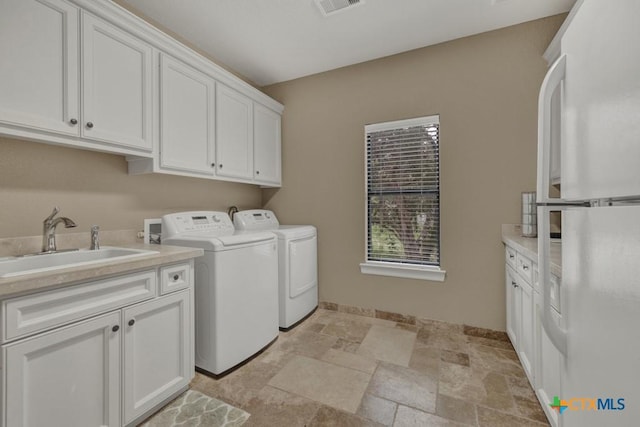 1746 Stagecoach Dr, Canyon Lake, TX 78133 - laundry area featuring cabinet space, independent washer and dryer, and light stone finish floors