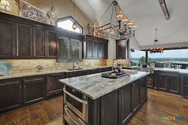 1746 Stagecoach Dr, Canyon Lake, TX 78133 - kitchen with a chandelier, backsplash, dark wood finished floors, dark brown cabinets, and high vaulted ceiling