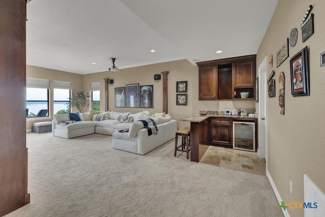 1746 Stagecoach Dr, Canyon Lake, TX 78133 - living room featuring light colored carpet, wine cooler, ornamental molding, and recessed lighting
