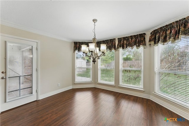 1711 Kelly Ct, New Braunfels, TX 78130 - unfurnished dining area with a chandelier, dark wood-style floors, plenty of natural light, and crown molding