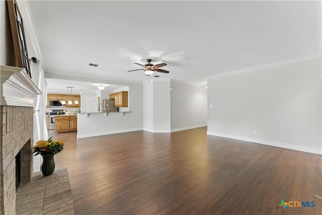 1711 Kelly Ct, New Braunfels, TX 78130 - unfurnished living room with ceiling fan, a brick fireplace, ornamental molding, and dark wood-type flooring