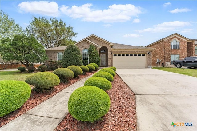 1711 Kelly Ct, New Braunfels, TX 78130 - view of front of property featuring a garage, brick siding, and concrete driveway