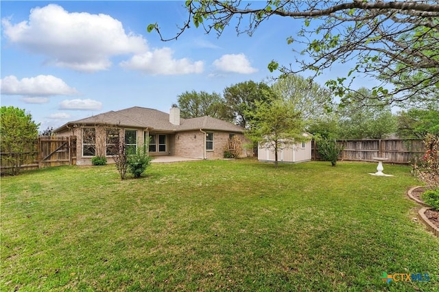 1711 Kelly Ct, New Braunfels, TX 78130 - rear view of house with a patio area, a chimney, a fenced backyard, brick siding, and a storage shed
