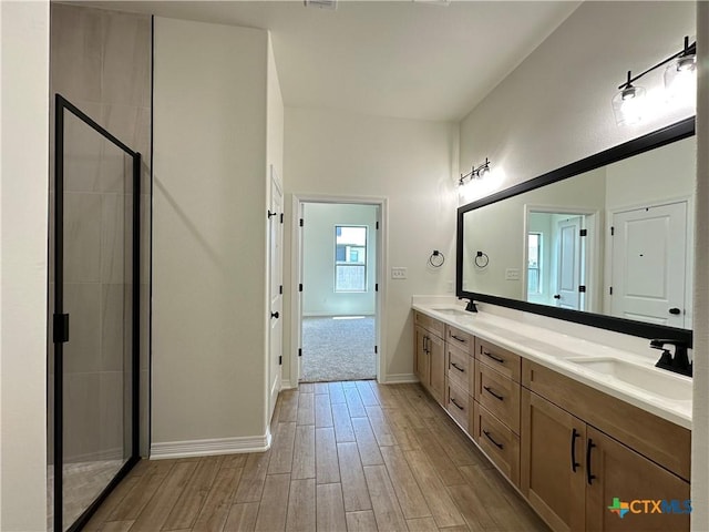505 Magnolia Dr, Troy, TX 76571 - bathroom with double vanity, wood finished floors, a shower stall, and baseboards