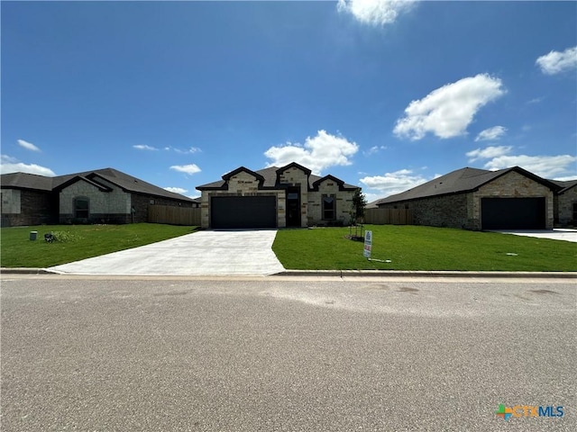 505 Magnolia Dr, Troy, TX 76571 - french country home featuring stone siding, concrete driveway, and a garage