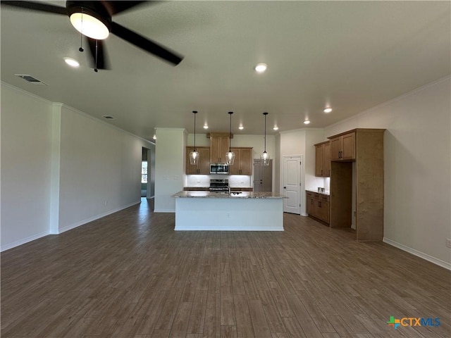 505 Magnolia Dr, Troy, TX 76571 - kitchen featuring stainless steel microwave, open floor plan, ornamental molding, dark wood-style floors, and pendant lighting