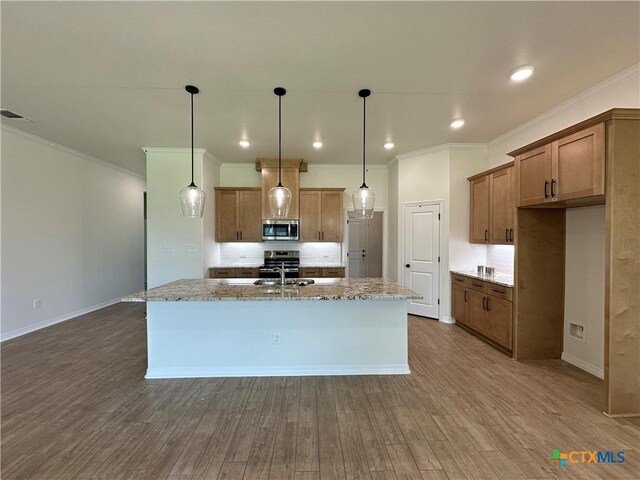 505 Magnolia Dr, Troy, TX 76571 - kitchen featuring stainless steel microwave, ornamental molding, brown cabinetry, a sink, and tasteful backsplash