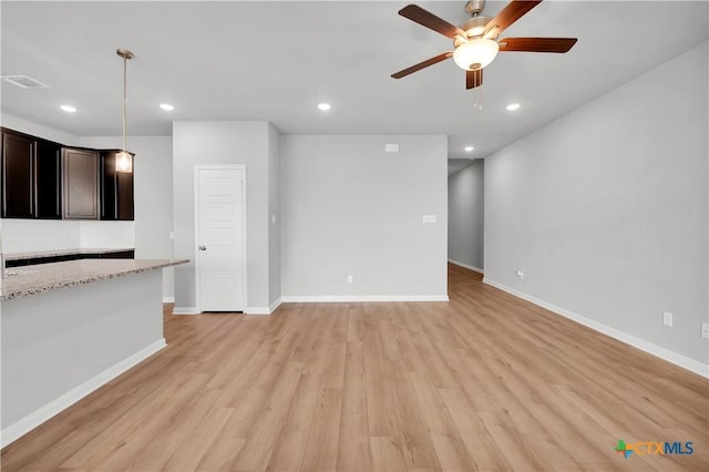 unfurnished living room featuring ceiling fan and light hardwood / wood-style flooring