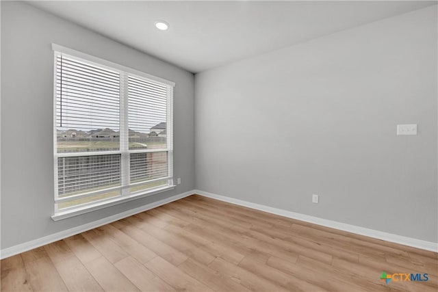 empty room with light hardwood / wood-style floors