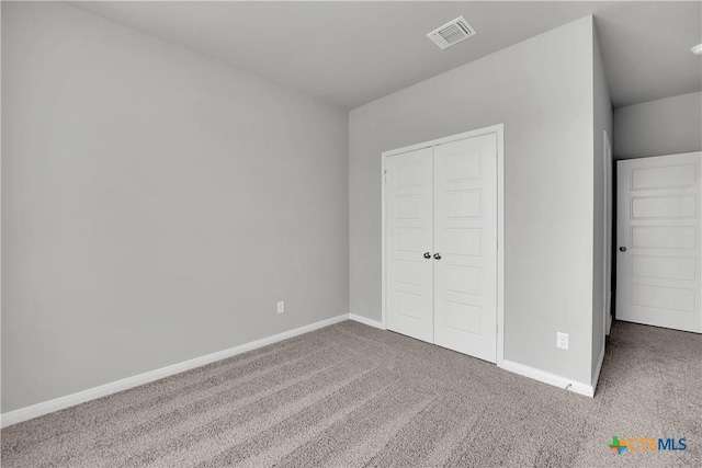 unfurnished bedroom with a closet and carpet