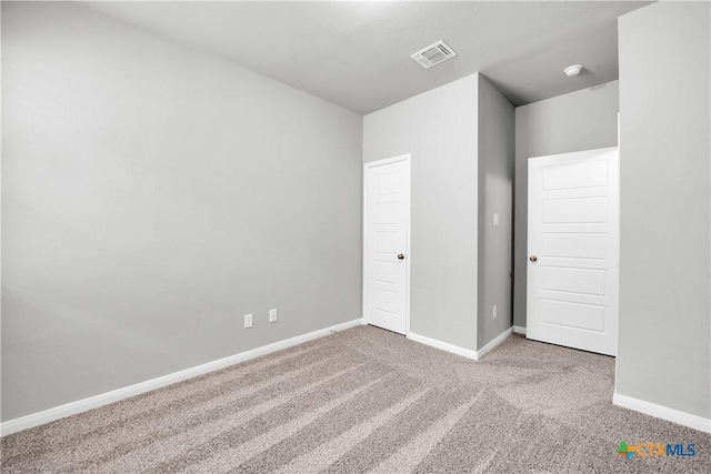 unfurnished bedroom with light colored carpet