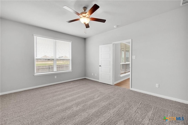 unfurnished bedroom with light colored carpet and ceiling fan