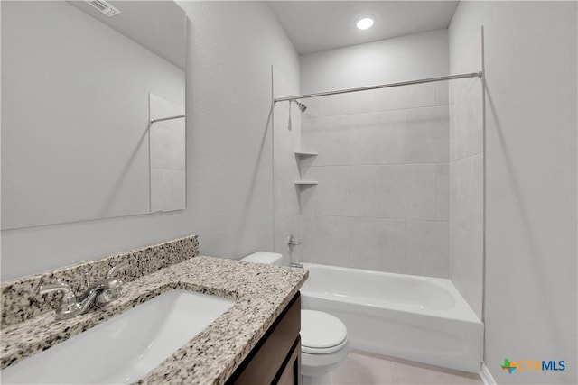 full bathroom with tiled shower / bath, vanity, and toilet