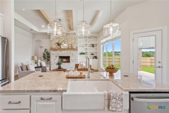 1702 Kellan Dr, Salado, TX 76571 - kitchen featuring stainless steel appliances, a sink, open floor plan, and light stone counters