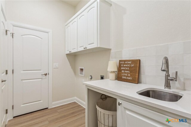 1702 Kellan Dr, Salado, TX 76571 - clothes washing area with cabinet space, washer hookup, hookup for an electric dryer, and light wood finished floors