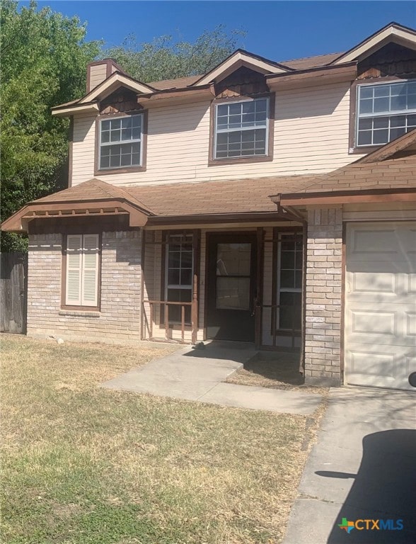2011 Hinkle Ave, Killeen, TX 76549 - view of front facade with a chimney, a front yard, roof with shingles, a garage, and brick siding