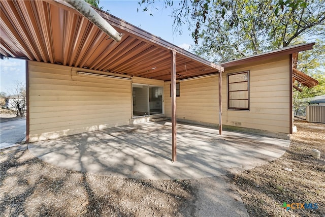 rear view of property with a patio area and cooling unit