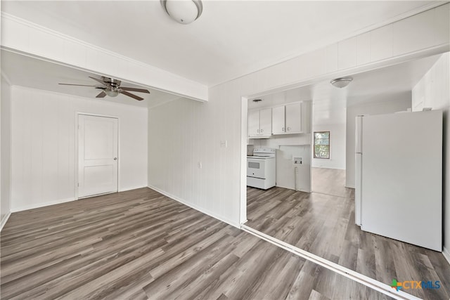 unfurnished living room with beamed ceiling, wood-type flooring, and ceiling fan