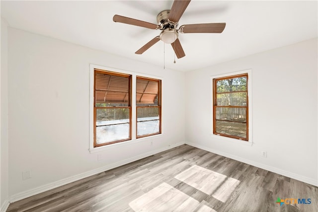 spare room with light hardwood / wood-style floors and ceiling fan