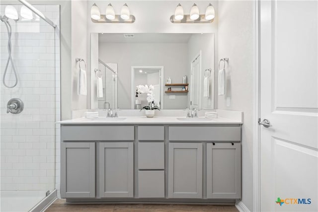 bathroom with walk in shower and vanity