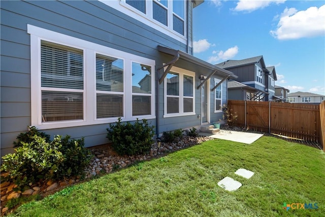 view of side of home with a lawn