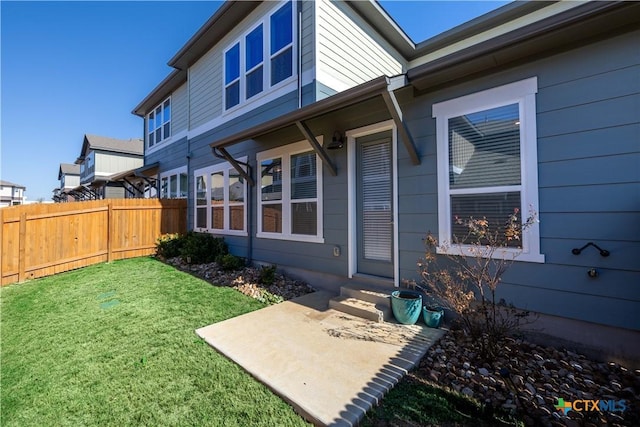 exterior space with a patio and a lawn