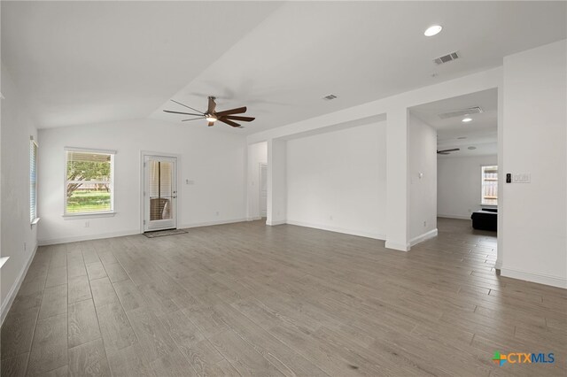 21203 Santa Rosa Ave, Lago Vista, TX 78645 - unfurnished living room featuring ceiling fan, wood finished floors, lofted ceiling, and recessed lighting
