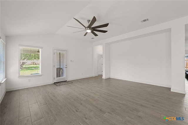 21203 Santa Rosa Ave, Lago Vista, TX 78645 - unfurnished living room with a ceiling fan, wood finished floors, and vaulted ceiling