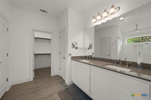 21203 Santa Rosa Ave, Lago Vista, TX 78645 - full bathroom with wood finished floors, double vanity, a shower with shower door, and a spacious closet