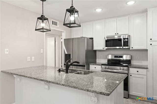 kitchen featuring appliances with stainless steel finishes, sink, and white cabinets