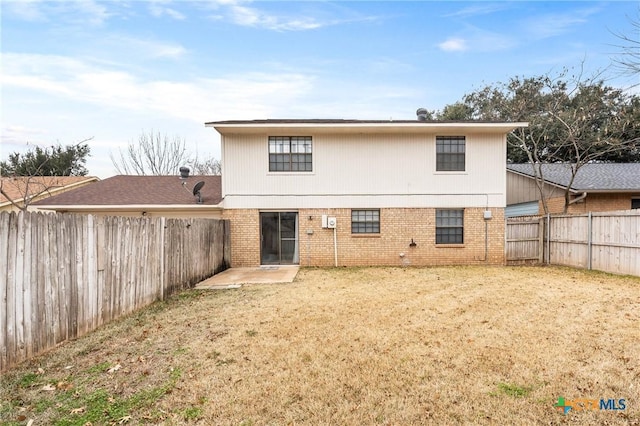 rear view of property with a patio and a lawn