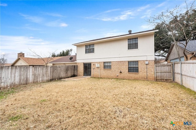 rear view of property with a lawn