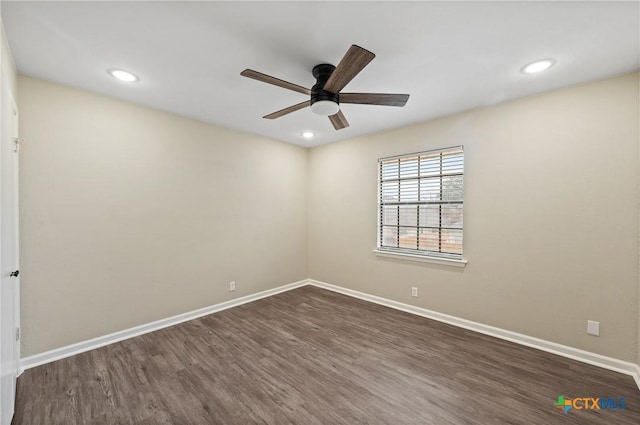 unfurnished room with ceiling fan and dark hardwood / wood-style flooring