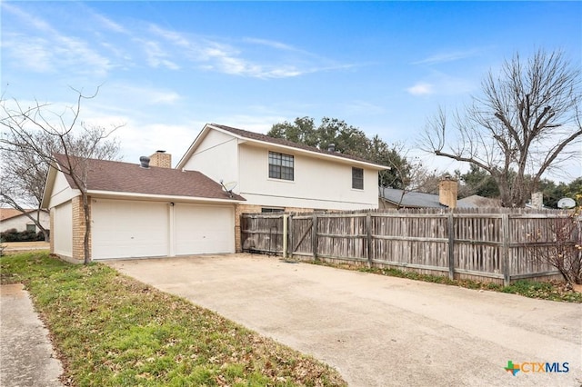 rear view of house with a garage