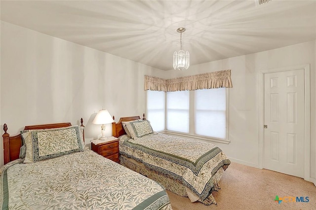 bedroom with carpet flooring and a notable chandelier