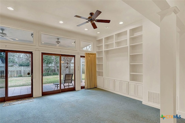 interior space featuring carpet floors, ceiling fan, and built in shelves