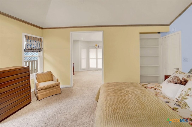 carpeted bedroom with multiple windows, crown molding, and vaulted ceiling