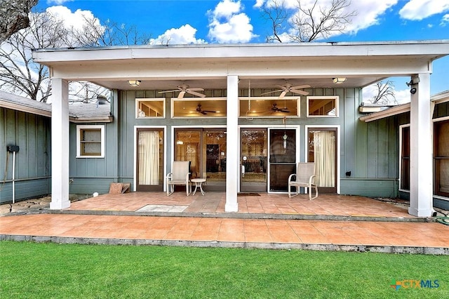 rear view of property featuring a lawn, a patio, and ceiling fan