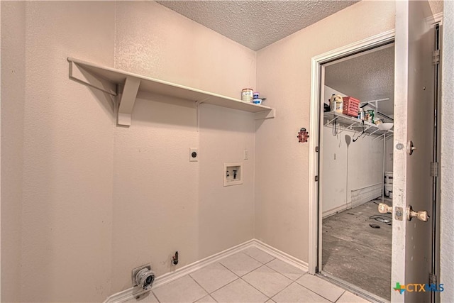 607 Moccasin Dr, Harker Heights, TX 76548 - laundry area featuring a textured ceiling, electric dryer hookup, light tile patterned floors, and washer hookup