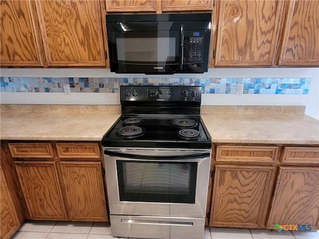 607 Moccasin Dr, Harker Heights, TX 76548 - kitchen featuring black microwave, electric range, light countertops, and decorative backsplash
