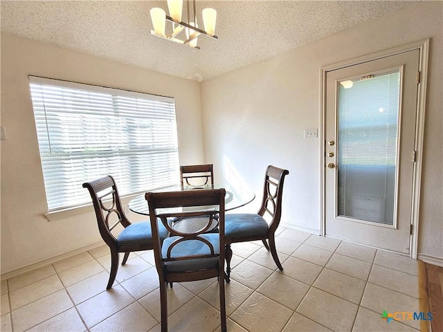 607 Moccasin Dr, Harker Heights, TX 76548 - dining area featuring a textured ceiling, light tile patterned floors, and a chandelier