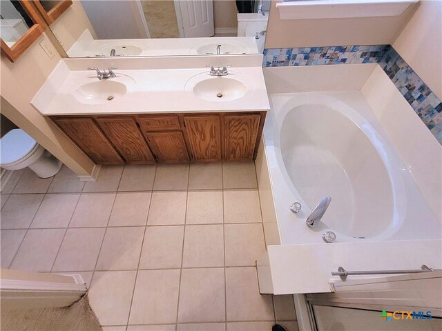 607 Moccasin Dr, Harker Heights, TX 76548 - bathroom featuring tile patterned floors, a bath, and double vanity