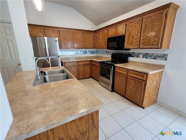 607 Moccasin Dr, Harker Heights, TX 76548 - kitchen with stainless steel appliances, lofted ceiling, brown cabinetry, light tile patterned flooring, and backsplash