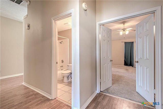 607 Moccasin Dr, Harker Heights, TX 76548 - hallway featuring a textured ceiling and wood finished floors