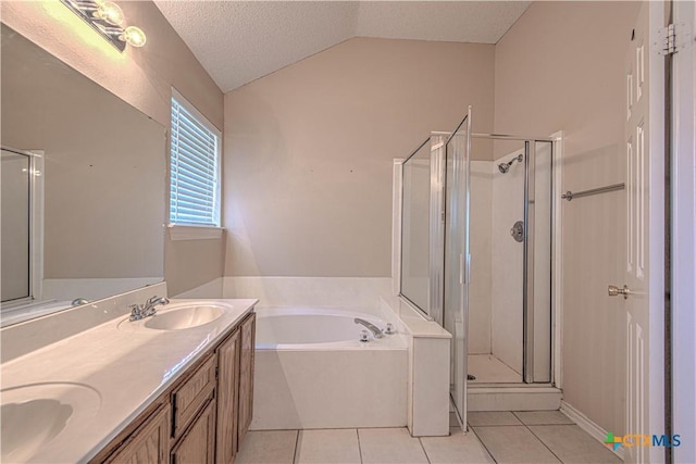 607 Moccasin Dr, Harker Heights, TX 76548 - full bath featuring vaulted ceiling, a bath, tile patterned flooring, a stall shower, and double vanity