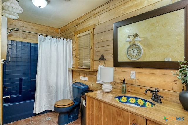 full bathroom with tile patterned flooring, vanity, toilet, and wood walls